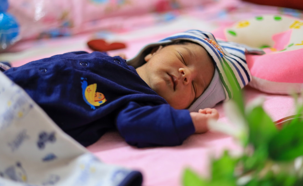 Peaceful sleeping newborn in soft light